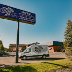 exterior signage and shuttle for the Heritage Inn