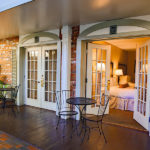 two queen beds guest room with french doors and atrium view