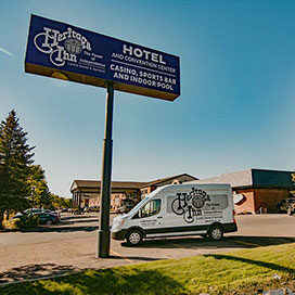 exterior signage and shuttle for the Heritage Inn